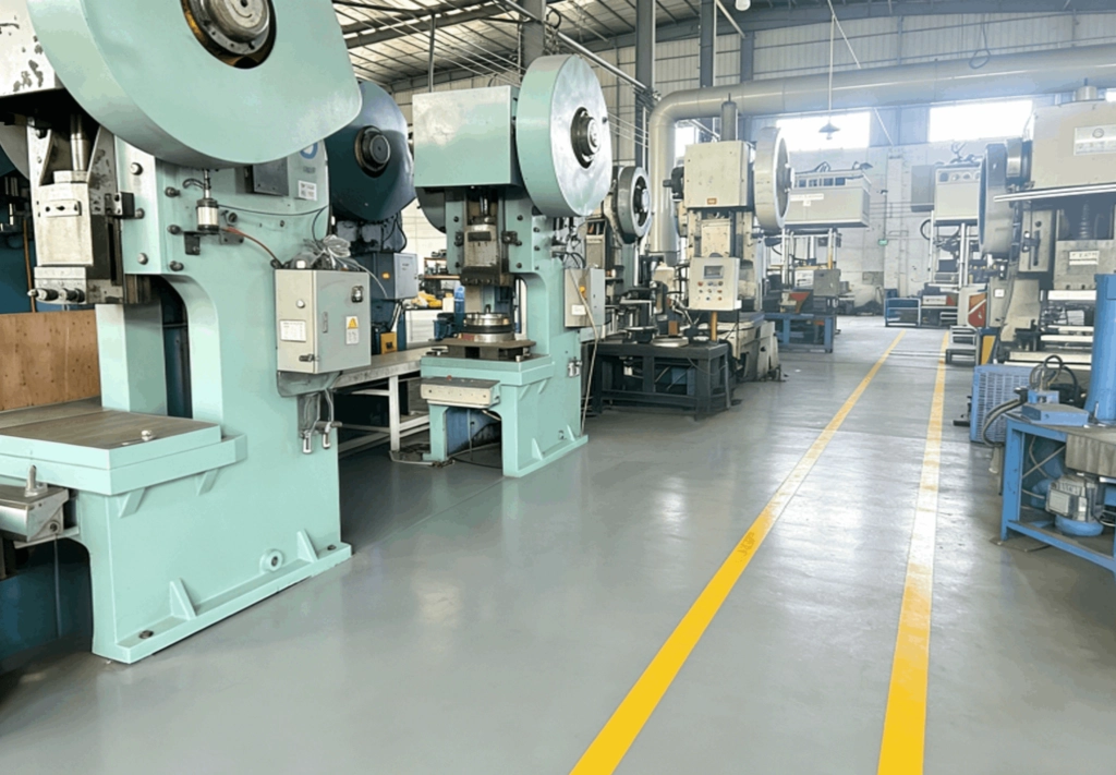 Modern induction cookware manufacturing factory with advanced machinery.